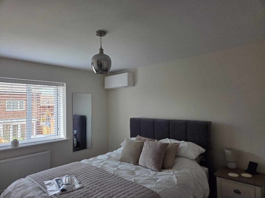 Chillmasters wall-mounted AC unit installed in a bedroom