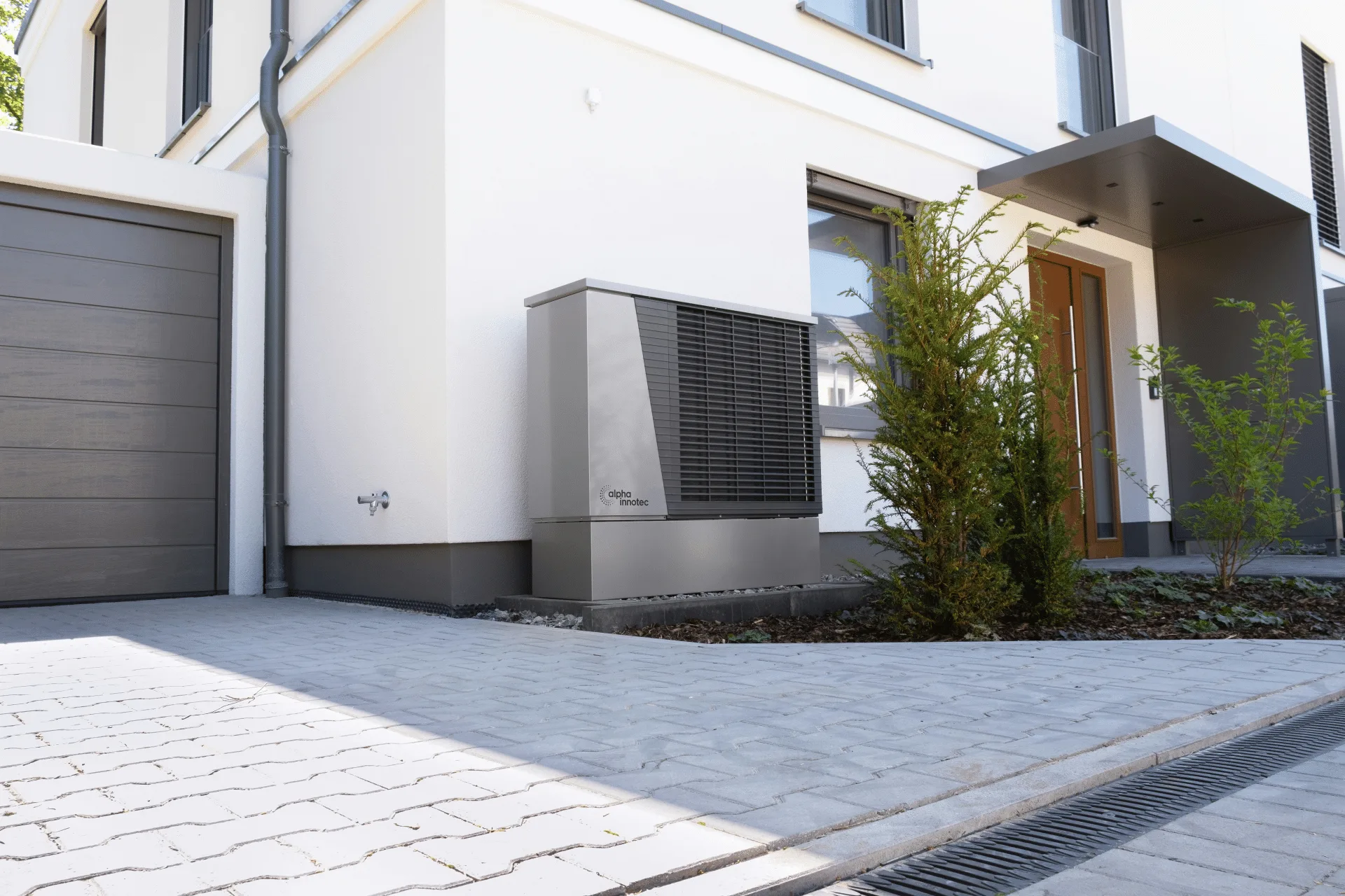 Modern air-to-air heat pump outdoor unit installed on a building exterior