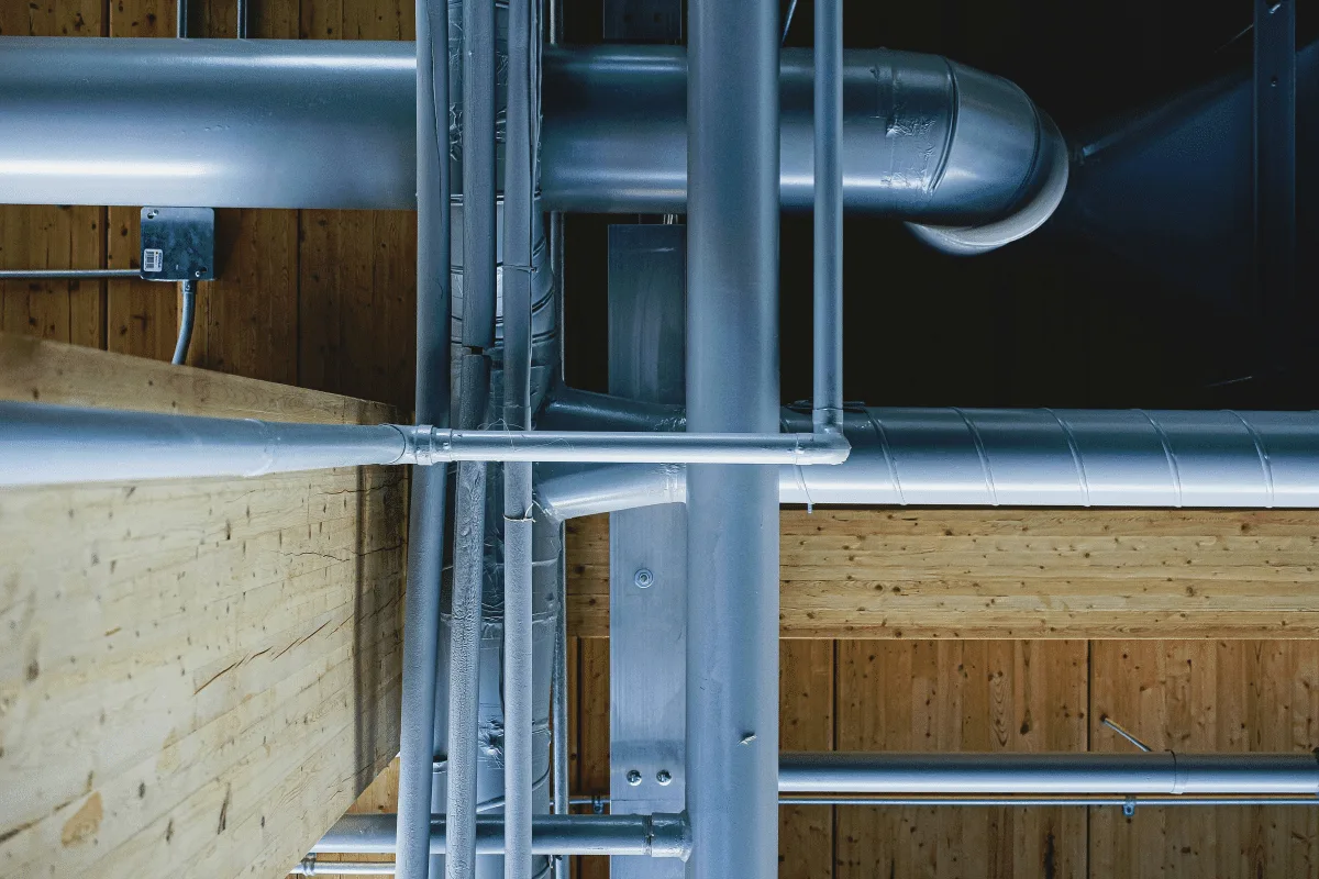 Plumber installing pipework for HVAC system