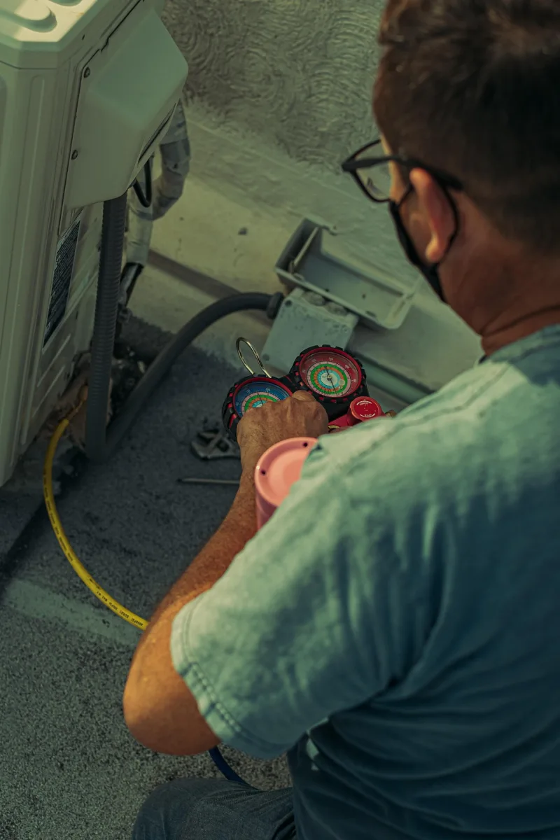 Engineer repairing an air conditioning unit