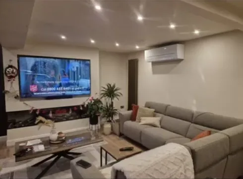 Wall-mounted split air conditioning unit installed in a modern living room